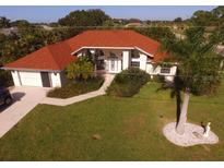 Single-Gathering home with red tile roof and large backyard at 1 Long Meadow Ln, Rotonda West, FL 33947