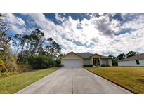 Single-story house with a driveway and well maintained lawn at 8235 Amendola Ave, North Port, FL 34291