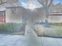 Exterior view of a two-story building with landscaping at 1200 Tarpon Woods Blvd # S2, Palm Harbor, FL 34685