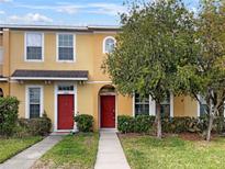 Beautiful two-story townhome with a red door at 8928 Red Beechwood Ct, Riverview, FL 33578