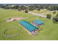 Aerial view of farm with barn and horse ring at 37600 Largo Ln, Dade City, FL 33523