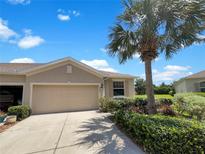 Charming single-story home featuring a two-car garage, mature landscaping, and a well-maintained lawn on a sunny day at 33083 Windelstraw Dr, Wesley Chapel, FL 33545