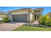 Attractive single-story house with a two-car garage and well-manicured lawn at 4915 Carova Way, Lakewood Ranch, FL 34211