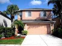Two-story home with a two-car garage and well-maintained landscaping for great curb appeal at 11774 Tempest Harbor Loop, Venice, FL 34292