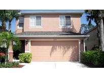 Inviting two-story home with a well-kept lawn, lush landscaping, and a spacious two-car garage at 11774 Tempest Harbor Loop, Venice, FL 34292