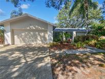 Charming single-story home featuring an attached garage, well-maintained landscaping, and a welcoming entrance at 3184 Wessex Way, Clearwater, FL 33761
