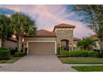 Stunning curb appeal with brick driveway and lush landscaping at 13219 Palermo Dr, Lakewood Ranch, FL 34211