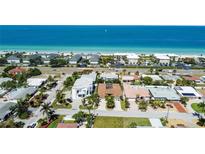 Aerial view of a beachfront property with ocean views and neighboring houses at 2504 Hibiscus W Dr, Belleair Beach, FL 33786