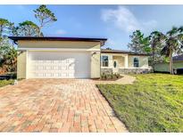 Newly constructed home with a brick driveway and garage at 368 Munoz St, Port Charlotte, FL 33953