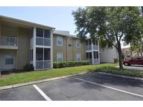 Two-story condo building with screened balconies and ample parking at 703 Parsons Lake Path # 104, Brandon, FL 33511