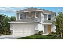 Two-story house with gray siding, white garage door and landscaping at 37498 Yukon Dr, Zephyrhills, FL 33540