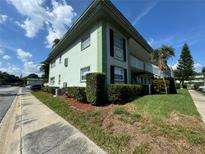 Exterior view of light green building with landscaping at 1433 S Belcher Rd # C1, Clearwater, FL 33764