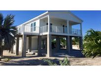 Elevated home with white exterior, balcony, and open floor plan at 2445 Tamworth Ter, Punta Gorda, FL 33983