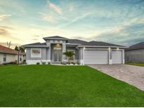 Attractive single-story home with three-car garage and well-manicured lawn at 287 Mariner Ln, Rotonda West, FL 33947