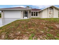 Charming single story home featuring a two-car garage and a well-manicured front yard at 3524 Cessna St, Port Charlotte, FL 33948