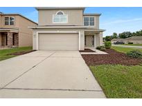 Inviting two-story home with a two car garage, manicured lawn, and neutral toned facade at 3444 97Th E Ln, Palmetto, FL 34221
