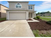 Two-story house with a two car garage and landscaped front yard at 3444 97Th E Ln, Palmetto, FL 34221