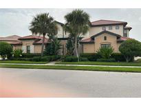 Charming two-story home with lush landscaping and a tile roof at 23598 Awabuki Dr # 102, Venice, FL 34293