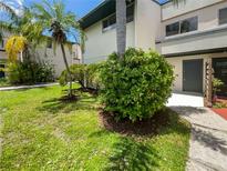 Front view of condo with landscaped lawn and walkway at 1052 Longfellow Cir, Sarasota, FL 34243
