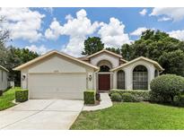 One-story home with attached garage and manicured lawn at 533 Bent Oak Ct, Spring Hill, FL 34609