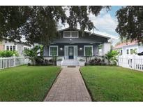 Charming bungalow with a gray exterior, white trim, and a landscaped front yard at 236 20Th Ave Se, St Petersburg, FL 33705