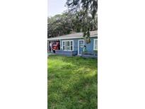 A charming blue home with a spacious yard and nautical accents at 7804 Chasco St, Port Richey, FL 34668