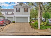 Two-car garage and front yard of townhome at 2111 Tetley Ct, Brandon, FL 33510