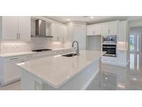 Modern kitchen with stainless steel appliances, a large island, and white cabinets at 4990 Fairhope Cir, Lakewood Ranch, FL 34211