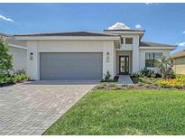 Charming single-story home with well-manicured lawn and a gray driveway, adding to its curb appeal at 4910 Carova Way, Lakewood Ranch, FL 34211