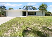 Newly renovated home with a large yard and driveway at 790 Harvard St, Englewood, FL 34223