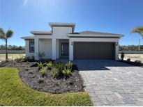 Charming single-story home with a neatly landscaped front yard and a two-car garage at 9613 Vibrant Lane, Venice, FL 34292