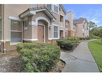 Apartment building with landscaped grounds and a concrete walkway at 10407 Villa View Cir # 10407, Tampa, FL 33647