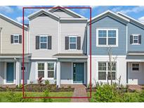 Charming two-story townhome with blue front door and manicured landscaping at 17326 Alderwood Ln, Punta Gorda, FL 33982