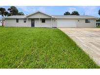 Newly renovated home with a two-car garage and spacious lawn at 1427 E Gate Dr, Venice, FL 34285