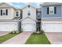 Three-unit townhome building with attached garages and landscaping at 17347 Peregrine Way, Punta Gorda, FL 33982