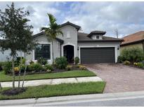 Charming single-story home with a well-manicured lawn and a two-car garage at 2633 Daisy Dr, North Port, FL 34289
