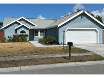 One-story house with a gray exterior, white garage door and walkway at 3529 65Th Avenue E Cir, Sarasota, FL 34243