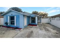 Charming light blue house with brick accents and a well-maintained yard at 8209 Reisling Pl, Tampa, FL 33615