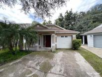 Cute one-story house with a one car garage and well-maintained lawn at 6115 Sand Key Ln, Wesley Chapel, FL 33545