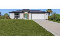 One-story home with a two-car garage and landscaped lawn at 3841 San Pedro Ave, North Port, FL 34288