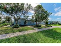 Charming light blue single story home with mature landscaping at 21475 Meehan Ave, Port Charlotte, FL 33952