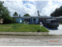 Single-story home with attached garage and yard at 3326 Supreme Dr, Holiday, FL 34691