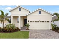 Exterior view of a charming one-story house with a paved driveway at 969 Signet, Apollo Beach, FL 33572