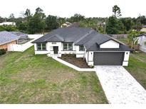 Charming new construction with paver driveway and neutral colors in a nicely landscaped neighborhood at 1081 Mccrory St, North Port, FL 34286