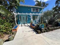 Charming teal home with landscaped walkway and porch at 105 Tucker Ave, Sarasota, FL 34232