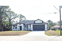 Charming one-story home with a spacious driveway and a well-maintained yard at 1294 Napoleon Rd, North Port, FL 34288