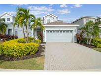 Two-story house with light blue exterior, gray roof and a paved driveway at 307 Shore Crab Way, Apollo Beach, FL 33572