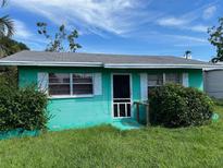 Light teal single story house with a small front yard at 524 29Th E St, Palmetto, FL 34221