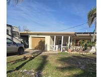 One-story house with a garage and a yard at 501 55Th Ave, St Pete Beach, FL 33706