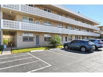Exterior view of condo building with parking lot and landscaping at 5095 Bay Ne St # 109, St Petersburg, FL 33703